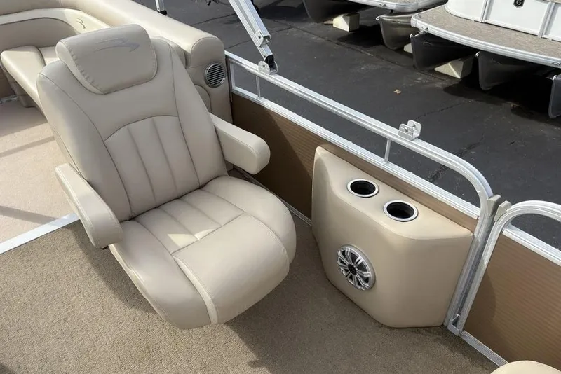 Slide: The Image of Luxurious seating on 2015 Bennington 24 SSRX pontoon boat with cup holders and speaker. - 21