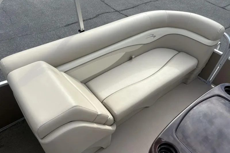 Slide: The Image of 2015 Bennington 24 SSRX boat interior with beige seating and table. - 22