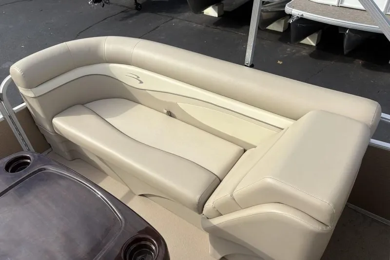 Slide: The Image of 2015 Bennington 24 SSRX pontoon boat with beige seating and cup holders. - 23