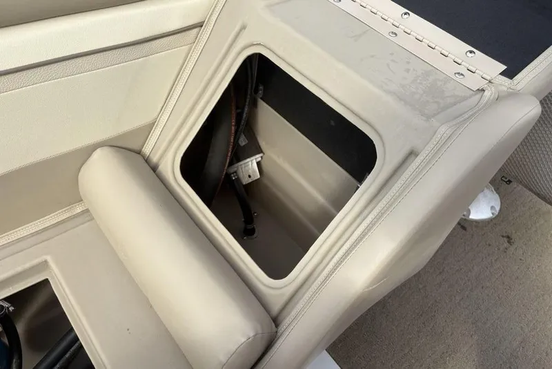 Slide: The Image of Open storage compartment in 2015 Bennington 24 SSRX boat, showcasing interior details. - 24