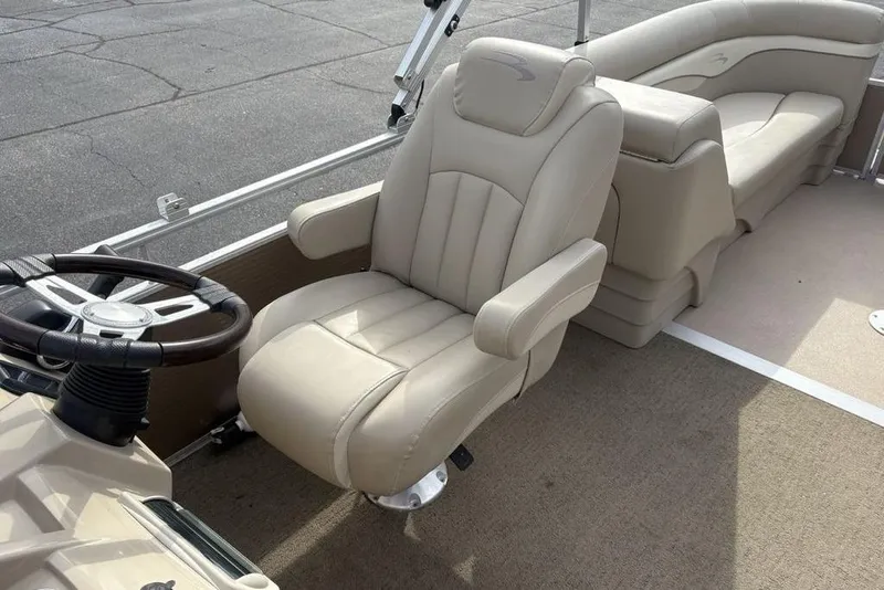 Slide: The Image of 2015 Bennington 24 SSRX boat interior with beige captain's chair and steering wheel. - 25