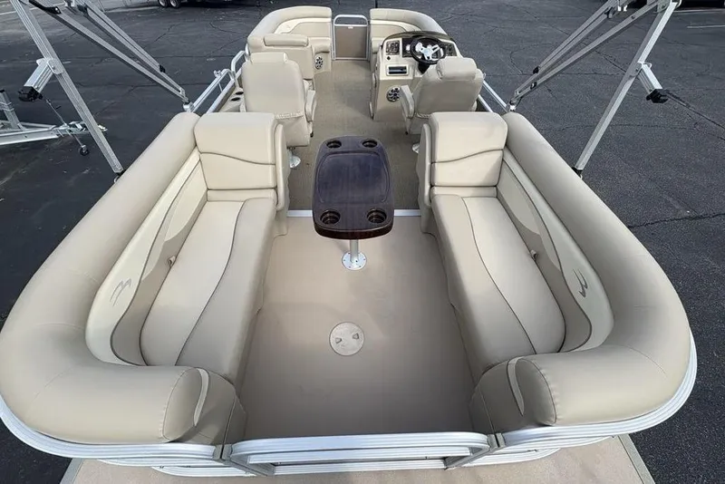 Slide: The Image of 2015 Bennington 24 SSRX pontoon boat with beige seating and central table. - 29