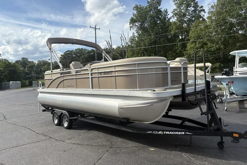 Slide: The Image of 2015 Bennington 24 SSRX pontoon boat on trailer, parked outdoors. - 3