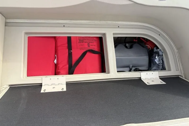 Slide: The Image of Storage compartment in a 2015 Bennington 24 SSRX boat with life jackets and equipment. - 30