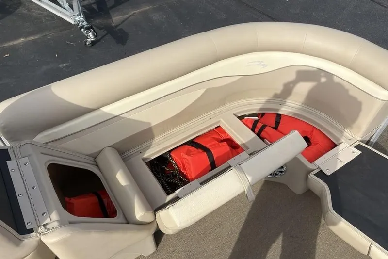 Slide: The Image of 2015 Bennington 24 SSRX boat interior with storage compartment and life jackets. - 4