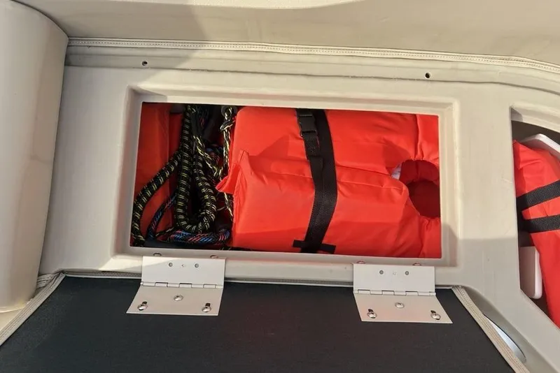 Slide: The Image of Storage compartment on 2015 Bennington 24 SSRX with life jackets and ropes. - 5