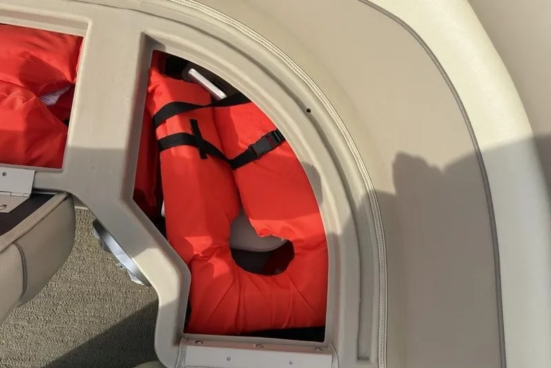 Slide: The Image of Storage compartment with life jackets on a 2015 Bennington 24 SSRX boat. - 6