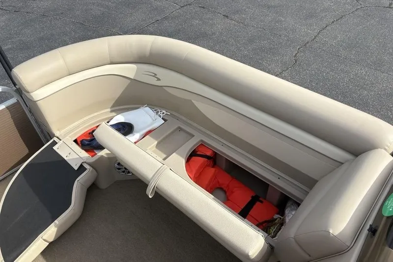 Slide: The Image of 2015 Bennington 24 SSRX boat interior with storage compartment and life jackets. - 8