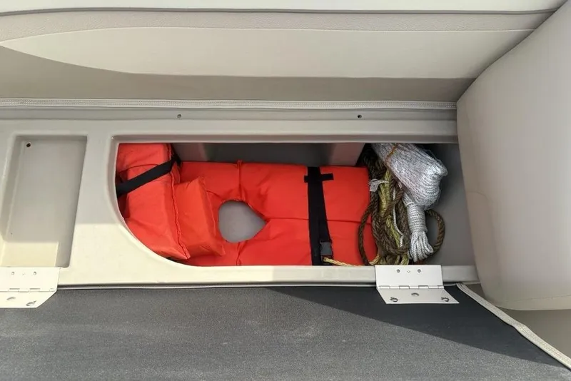 Slide: The Image of Storage compartment in a 2015 Bennington 24 SSRX boat with life jacket and ropes. - 9