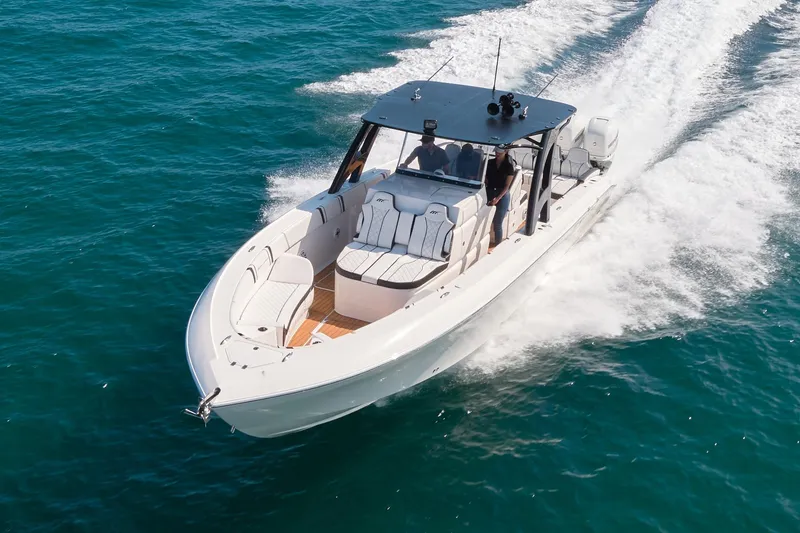 Slide: The Image of 2020 Midnight Express 37' Open boat cruising on clear blue water. - 2