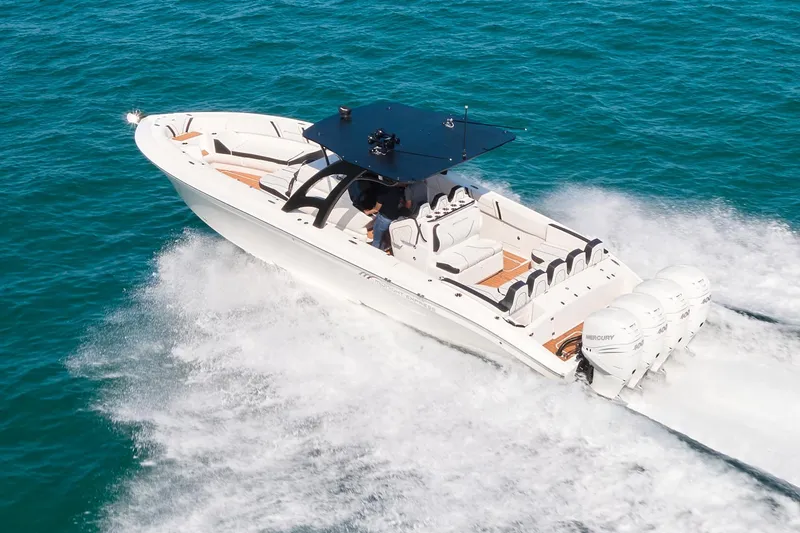 Slide: The Image of 2020 Midnight Express 37' Open boat cruising on clear blue water. - 3