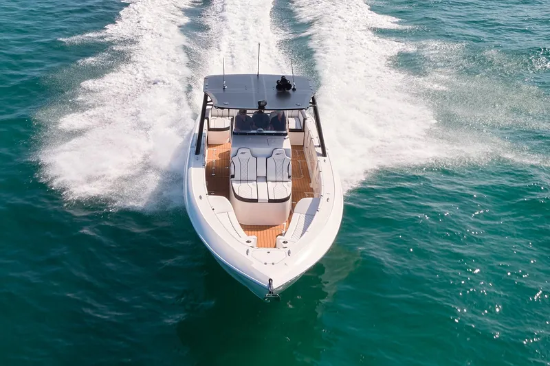 Slide: The Image of 2020 Midnight Express 37' Open boat cruising on clear blue water. - 4