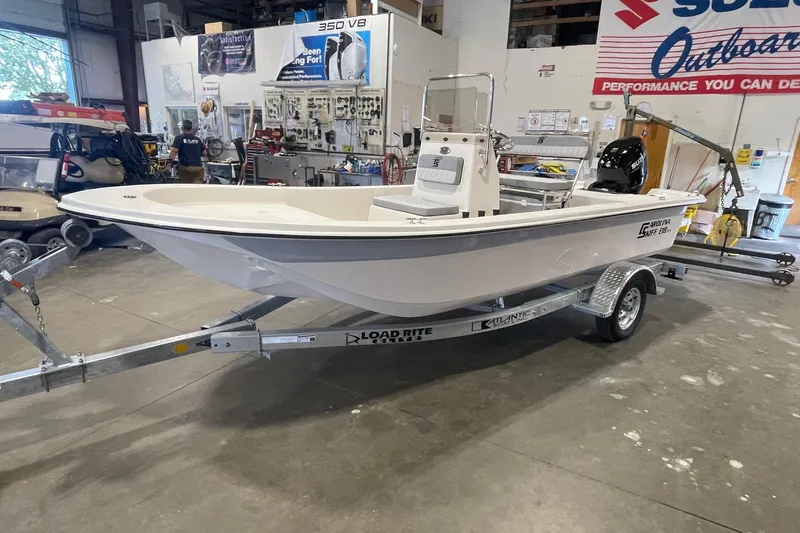 Slide: The Image of 2026 Carolina Skiff E18 JVX CC boat on trailer in a showroom. - 3