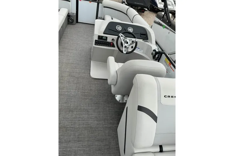 Slide: The Image of 2023 Crest Classic LX 220 boat interior with modern steering and comfortable seating. - 11