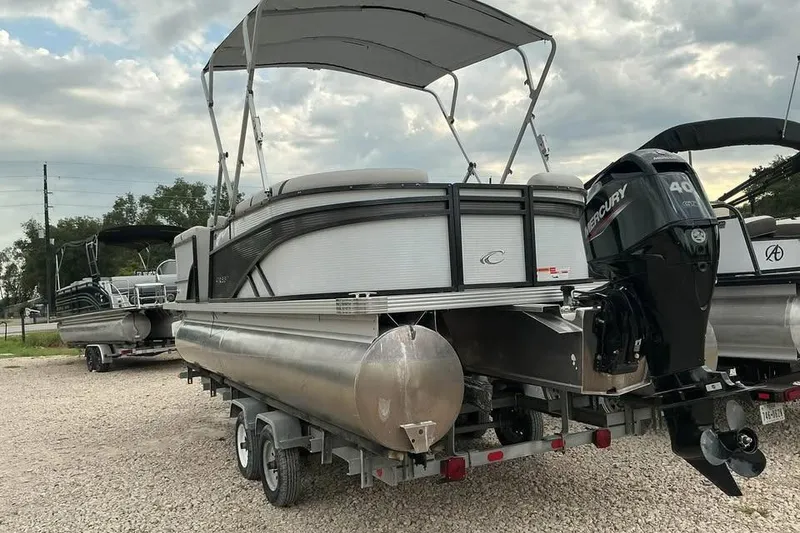 Slide: The Image of 2023 Crest Classic LX 220 pontoon boat with Mercury engine on trailer. - 3