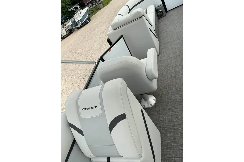 Slide: The Image of 2023 Crest Classic LX 220 boat interior with plush seating and modern design. - 7