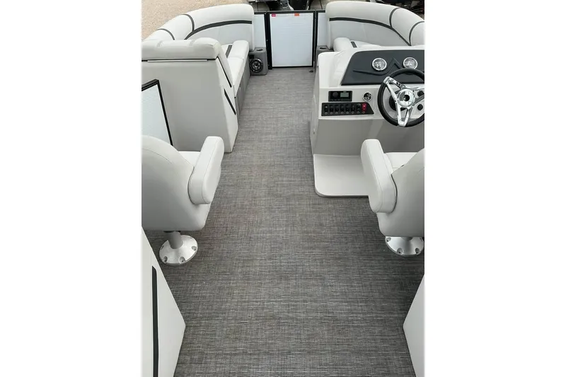 Slide: The Image of 2023 Crest Classic LX 220 boat interior with gray flooring and modern seating. - 8