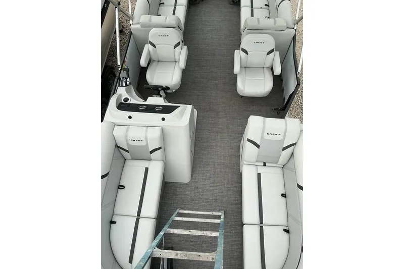 Slide: The Image of 2023 Crest Classic LX 220 boat interior with white seating and modern design. - 9