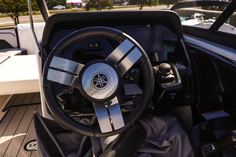 Slide: The Image of Steering wheel of 2019 Yamaha Boats 212X, featuring sleek design and modern controls. - 13