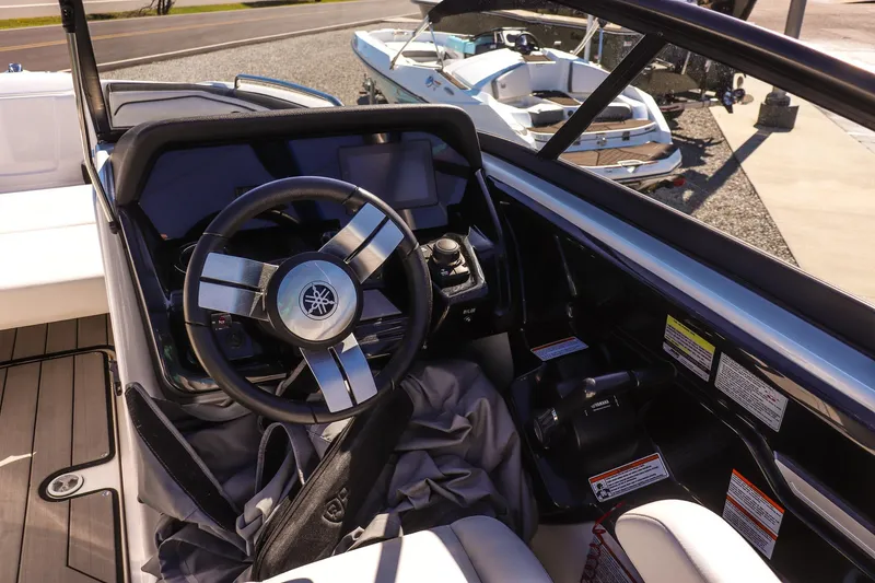 Slide: The Image of 2019 Yamaha Boats 212X steering console with modern controls and sleek design. - 14