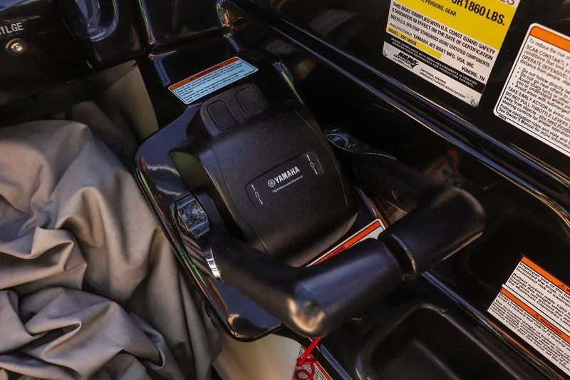 Slide: The Image of Close-up of 2019 Yamaha Boats 212X throttle control with safety labels. - 15