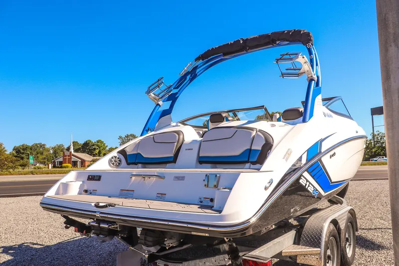 Slide: The Image of 2019 Yamaha Boats 212X on trailer, sleek design, blue and white color scheme. - 5