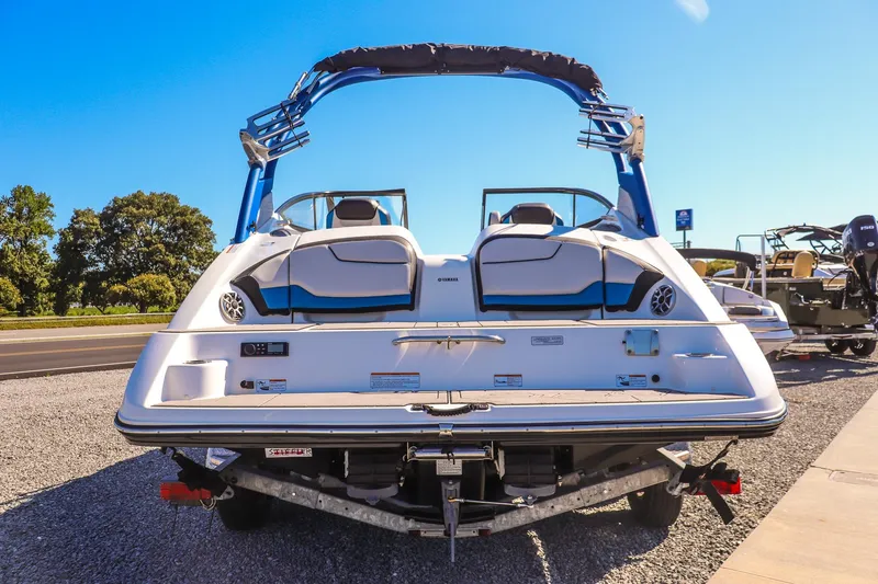 Slide: The Image of 2019 Yamaha Boats 212X, rear view, on trailer, sunny day, outdoor display. - 6