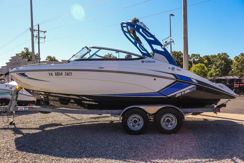 Slide: The Image of 2019 Yamaha Boats 212X on trailer, parked outdoors, sunny day. - 8