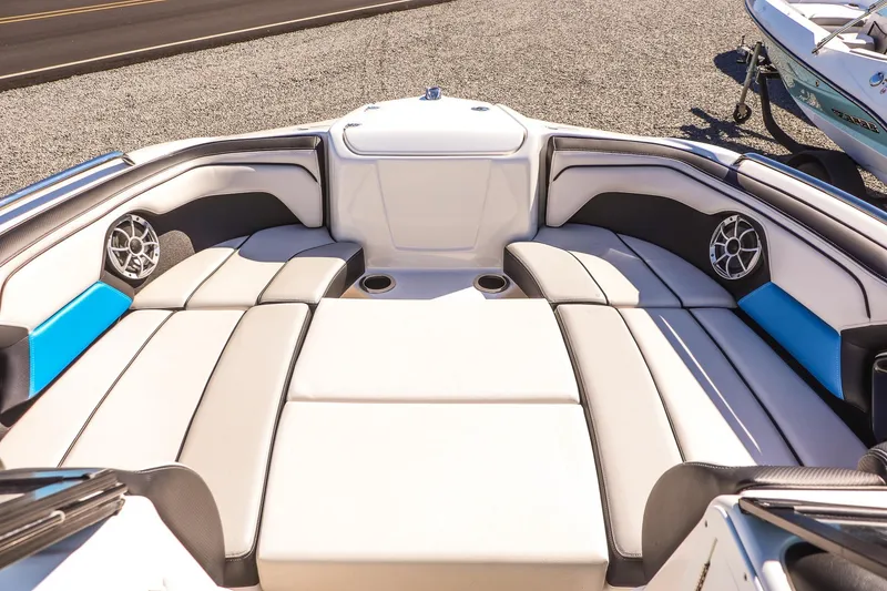 Slide: The Image of 2019 Yamaha Boats 212X interior with cushioned seating and built-in speakers. - 9