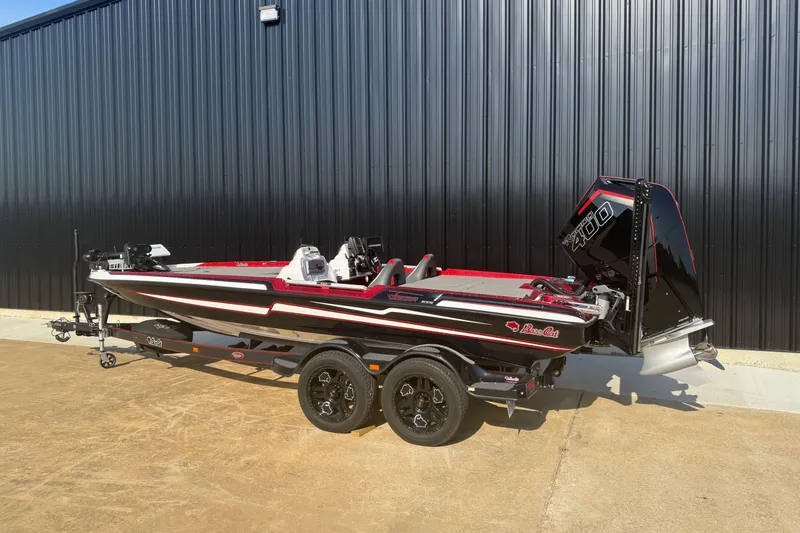 Slide: The Image of 2023 Bass Cat Jaguar STS boat with powerful engine, parked on a trailer. - 2