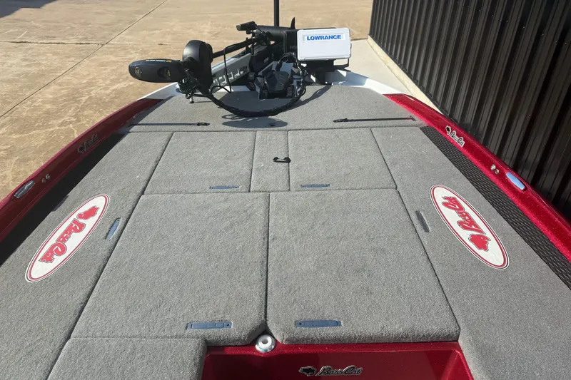 Slide: The Image of 2023 Bass Cat Jaguar STS boat deck with Lowrance equipment, red and gray design. - 5