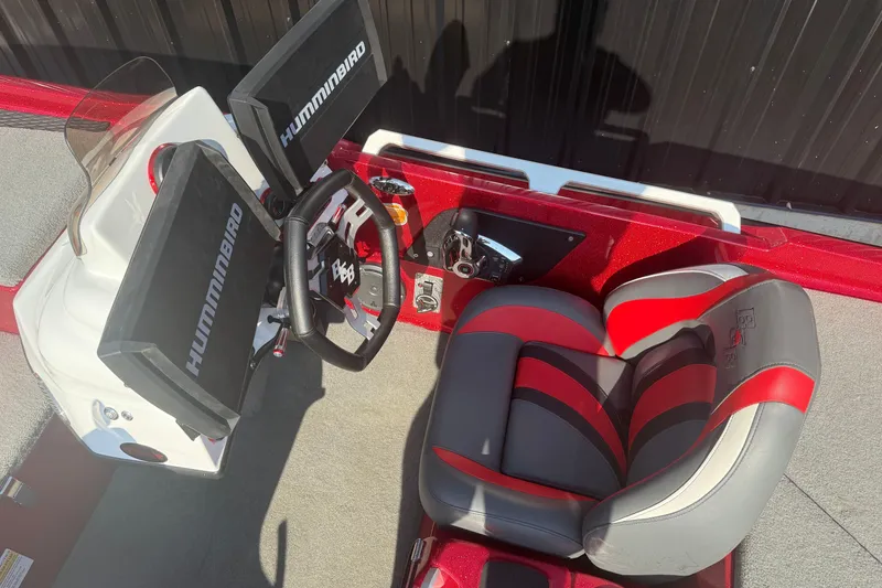 Slide: The Image of 2023 Bass Cat Jaguar STS boat cockpit with dual Humminbird displays and red-gray seating. - 8