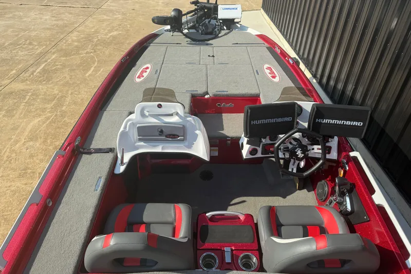 Slide: The Image of 2023 Bass Cat Jaguar STS boat interior with dual Humminbird displays and red-gray seating. - 9