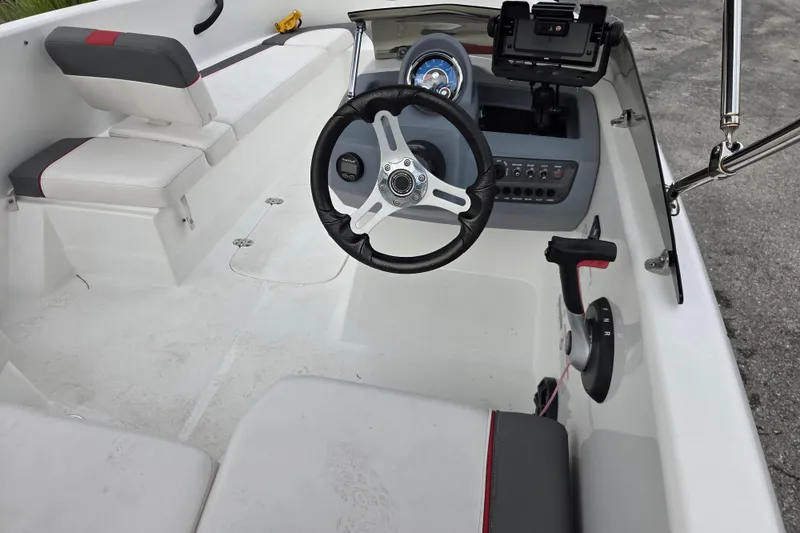 Slide: The Image of Interior of a 2022 Tahoe T16 boat featuring steering wheel and control panel. - 4