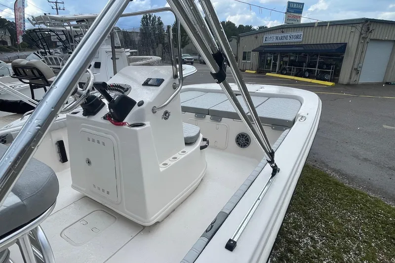 Slide: The Image of 2026 Carolina Skiff 19 LS boat at a marine store, showcasing interior and controls. - 4
