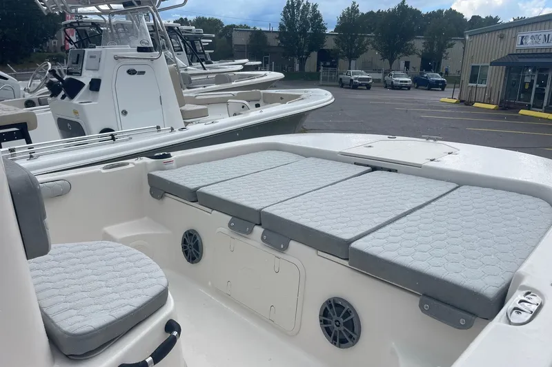 Slide: The Image of 2026 Carolina Skiff 19 LS boat interior with cushioned seating and storage compartments. - 7