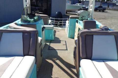 Slide: The Image of 2018 Caravelle Razor 238 PF boat interior with seating and helm, docked outdoors. - 11