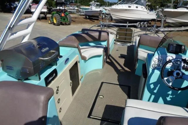 Slide: The Image of 2018 Caravelle Razor 238 PF boat interior with seating, grill, and control panel. - 15