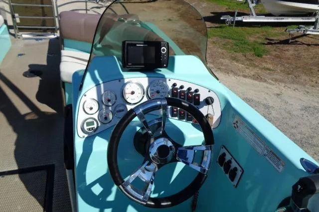 Slide: The Image of 2018 Caravelle Razor 238 PF boat dashboard with steering wheel and control panel. - 16