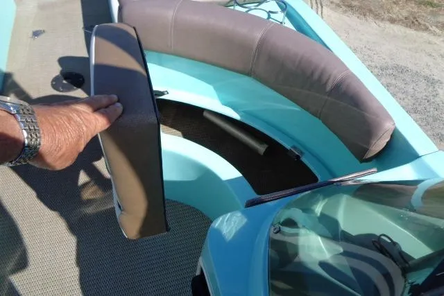 Slide: The Image of 2018 Caravelle Razor 238 PF boat interior with storage compartment open. - 19