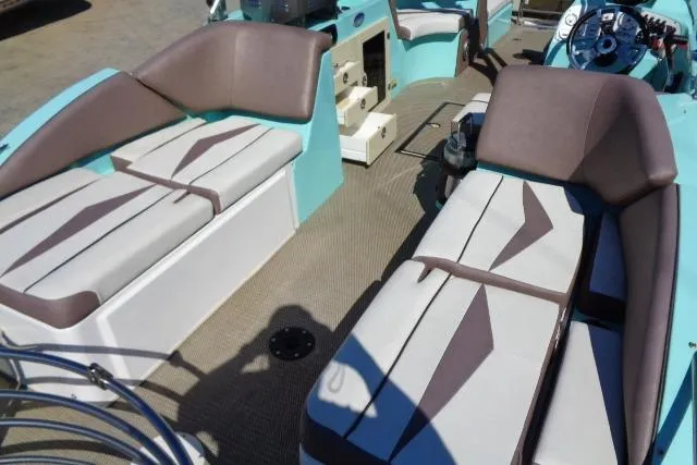 Slide: The Image of 2018 Caravelle Razor 238 PF boat interior with cushioned seating and steering console. - 20