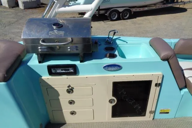 Slide: The Image of 2018 Caravelle Razor 238 PF boat with grill, sink, and storage compartments. - 25