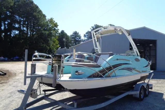 Slide: The Image of 2018 Caravelle Razor 238 PF boat on trailer near a storage building. - 9