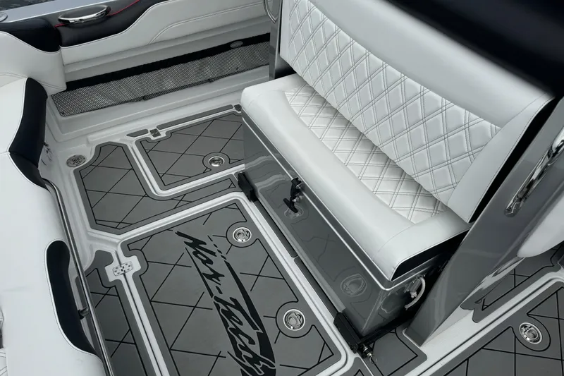 Slide: The Image of 2022 Nor-Tech 390 Sport Center Console interior with diamond-stitched seating and custom flooring. - 12