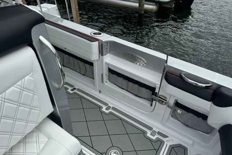 Slide: The Image of 2022 Nor-Tech 390 Sport Center Console boat interior with quilted seating and storage compartments. - 13