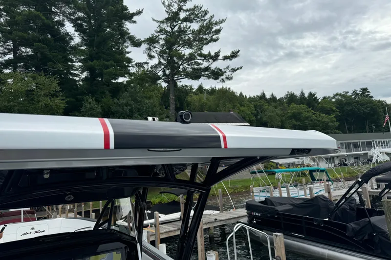 Slide: The Image of 2022 Nor-Tech 390 Sport Center Console boat docked, featuring sleek design and vibrant accents. - 15