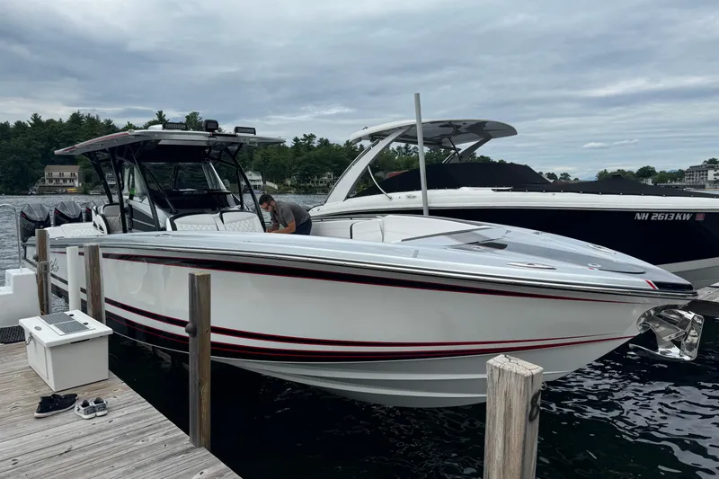 Slide: The Image of 2022 Nor-Tech 390 Sport Center Console boat docked, featuring sleek design and modern amenities. - 18