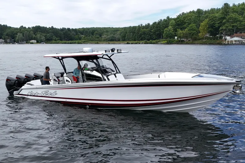 Slide: The Image of 2022 Nor-Tech 390 Sport Center Console boat on a scenic lake. - 4