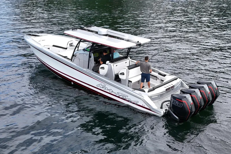 Slide: The Image of 2022 Nor-Tech 390 Sport Center Console boat on water with four powerful engines. - 5
