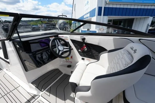 Slide: The Image of 2026 Sea Ray SPX 210 boat interior with steering wheel and seating, showcasing modern design. - 12
